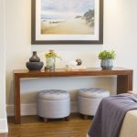 Interior designer Redondo Beach CA console table with ottomans beneath and beach painting above