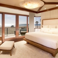 Hermosa Beach Interior Designers contemporary beachfront master bedroom with flush mount light fixture, wood bed-frame and white drapery open