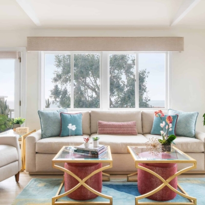 Custom Manhattan Beach Home contemporary living room with red upholstered ottomans and gold side tables.