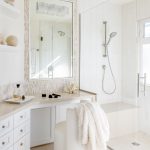 Bright and beachy master bathroom makeup vanity with white upholstered chair in Manhattan Beach