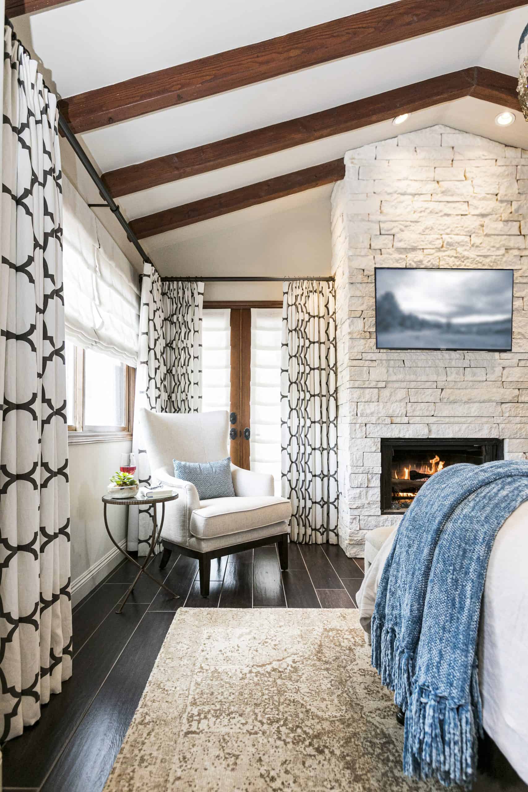 https://aboutspacestudios.com/wp-content/uploads/2020/02/Santa-Barbara-Spanish-Bedroom-Fireplace-Design-scaled.jpg